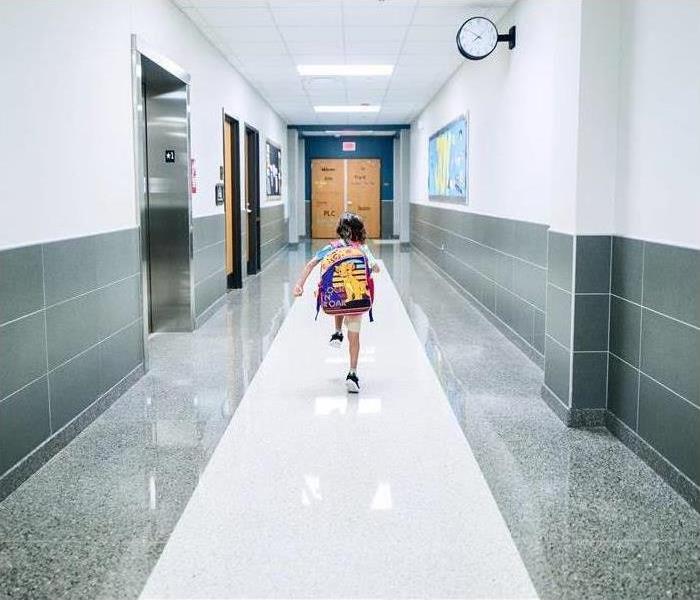 A child walking down school hallway